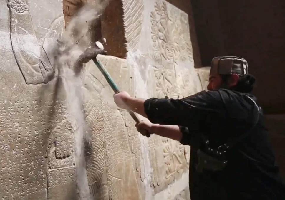 ISIS militant destroys Assyrian sculpture, Mosul, Iraq